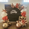 Gold Circle Stand with Balloon Garland and Neon Light
