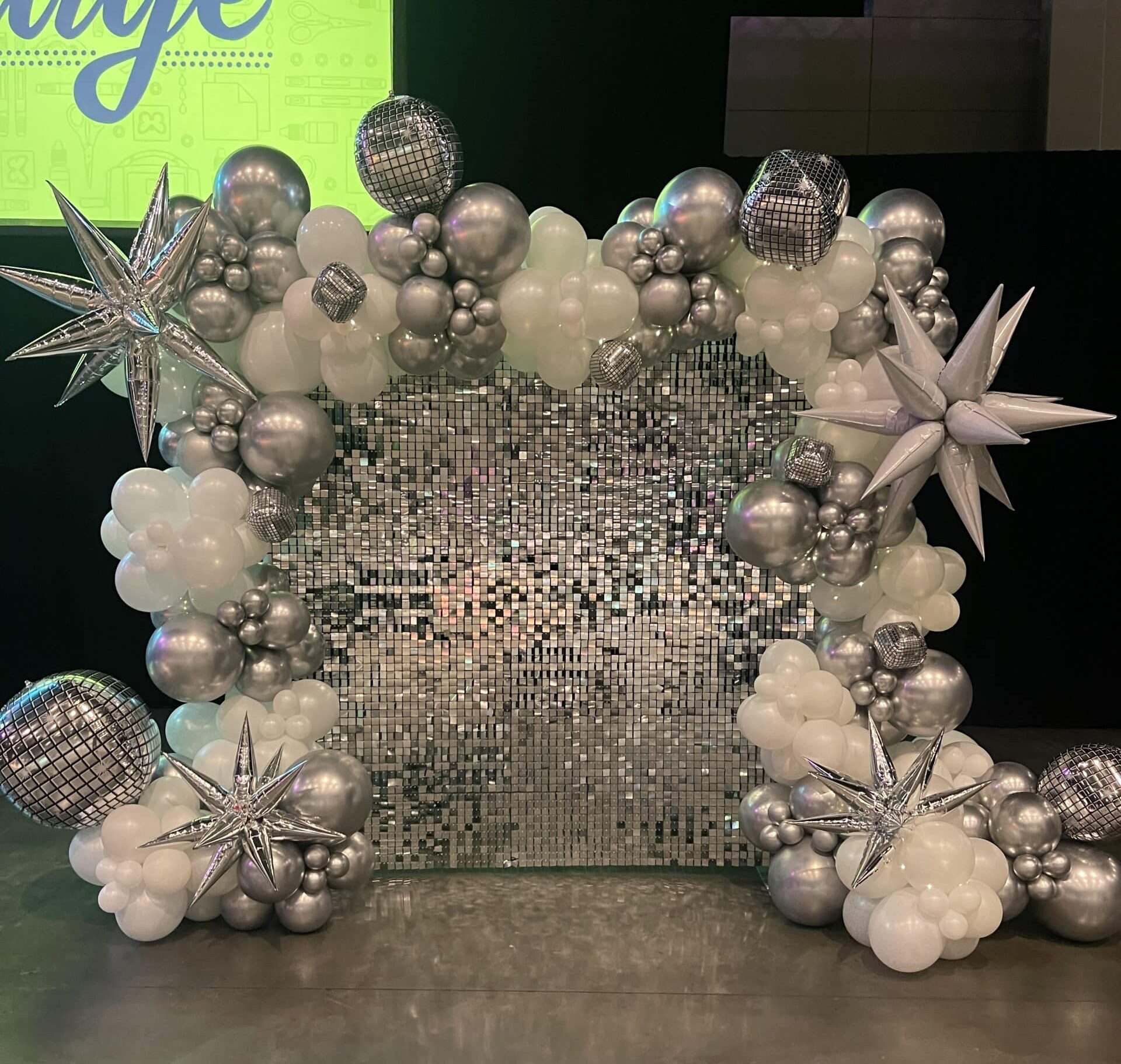 silver shimmer wall with organic balloon garland for delivery and setup in Raleigh Nc and the triangle