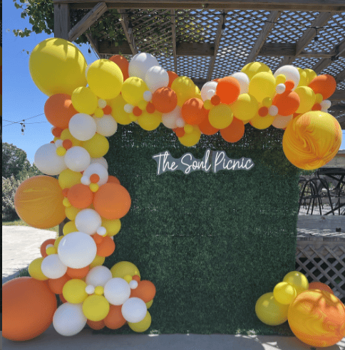 Grass wall backdrop w organic balloon garland in Raleigh Nc delivery and set